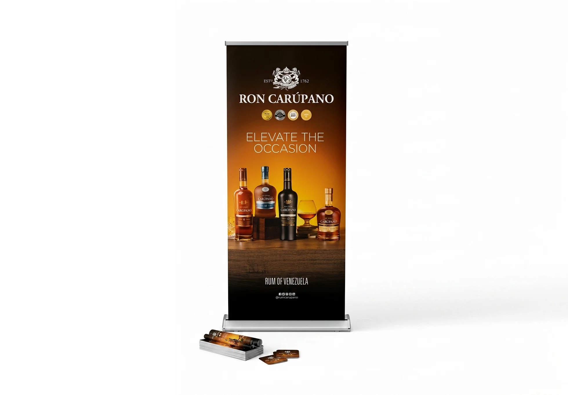 Printed roller banner on its cassette base showing a Venezuelan rum brand's bottles, with printed cards stacked in front