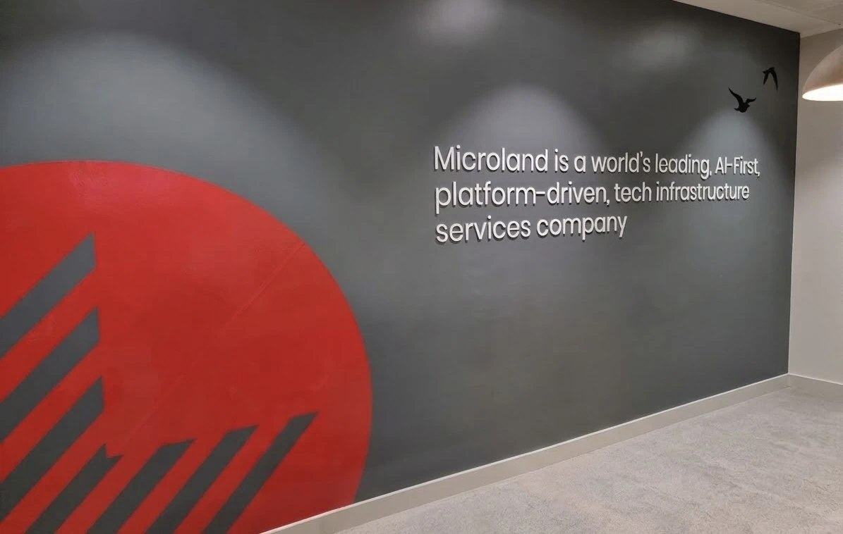 Finished office feature wall with printed graphics and dimensional lettering spelling out a company statement