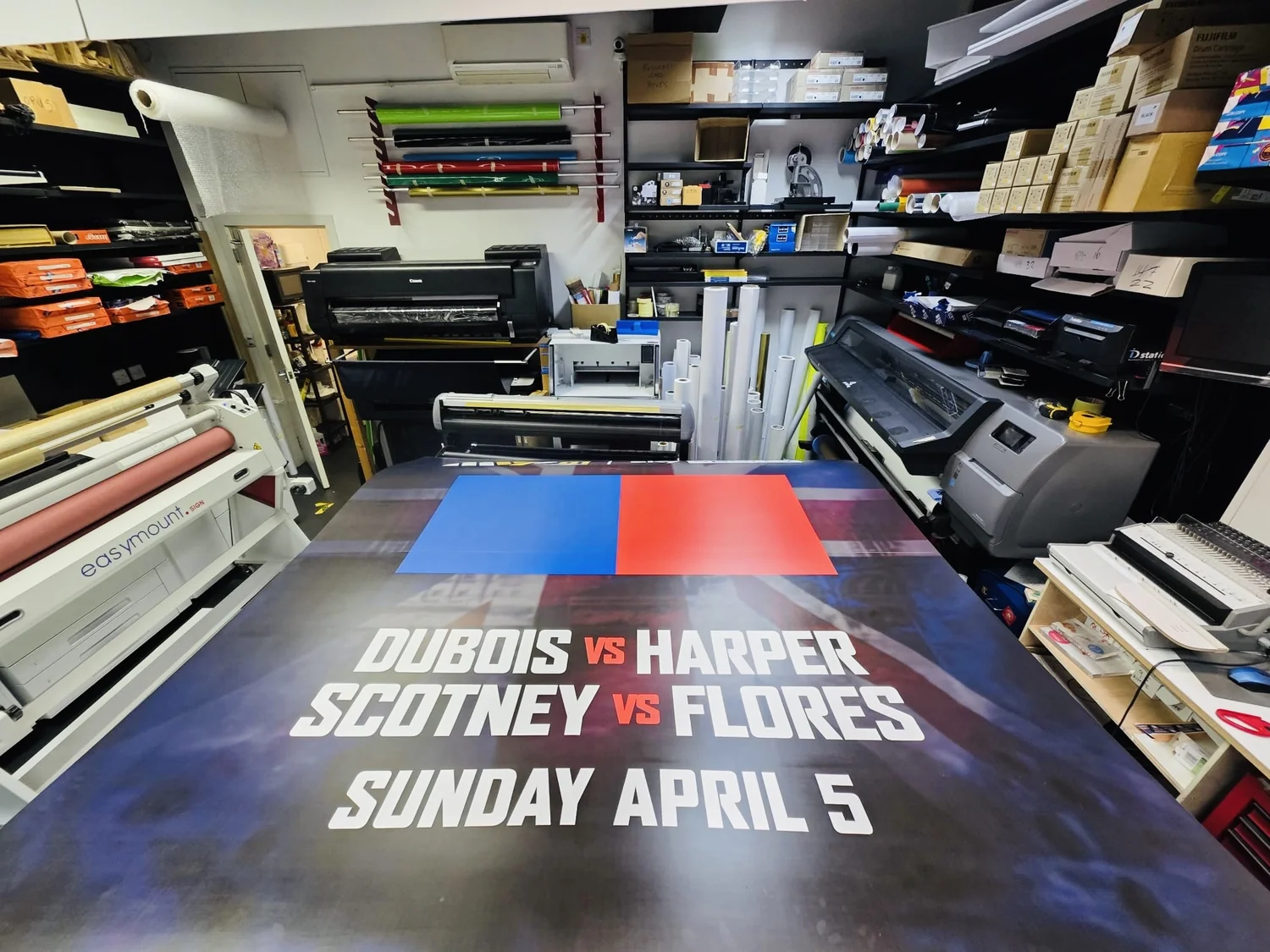 The 8 x 8 ft event graphic on the finishing table of our London production floor during the overnight run, laminator alongside