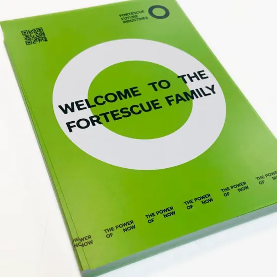 Green Fortescue Future Industries welcome booklet with a white ring device on the cover