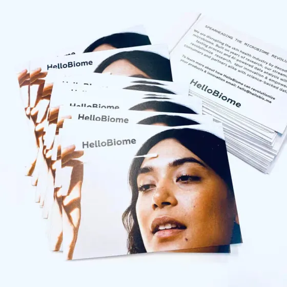 HelloBiome postcards and business cards fanned across a white surface
