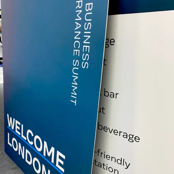 Blue Meta Small Business Performance Summit welcome panel beside a printed menu board