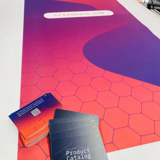 Ursa Space roller banner graphic laid flat with matching product catalogues and business cards