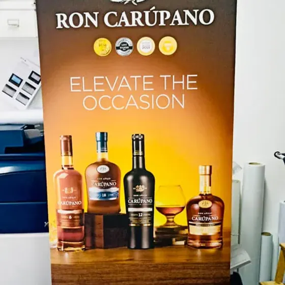 Dark roller banner for Ron Carupano rum showing bottles against a black background