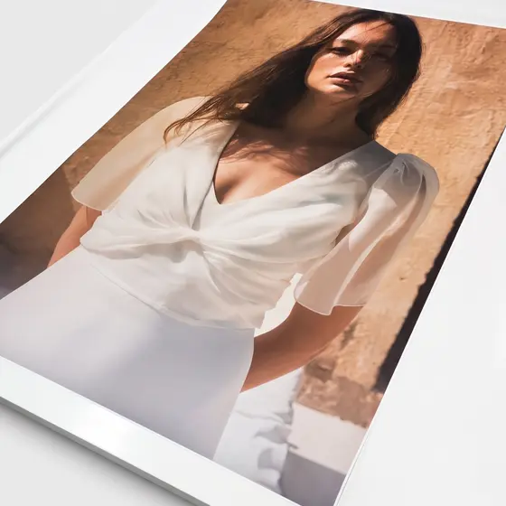A lookbook lying open, the visible page filled by a full-bleed fashion photograph