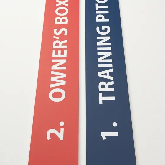 A pair of printed wayfinding arrow signs.