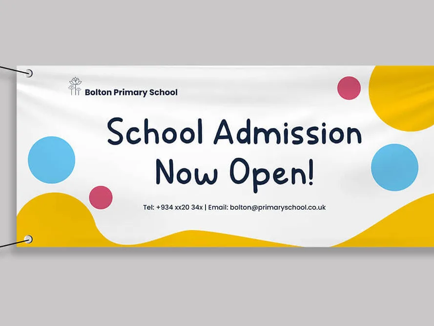 Wide banner reading School Admission Now Open stretched between two posts