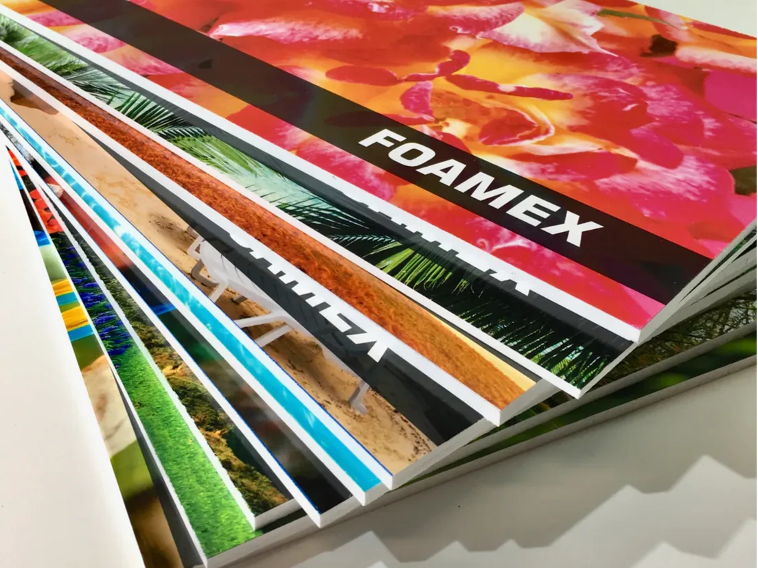 Stack of printed foam boards fanned out to show the white board edges, one labelled Foamex