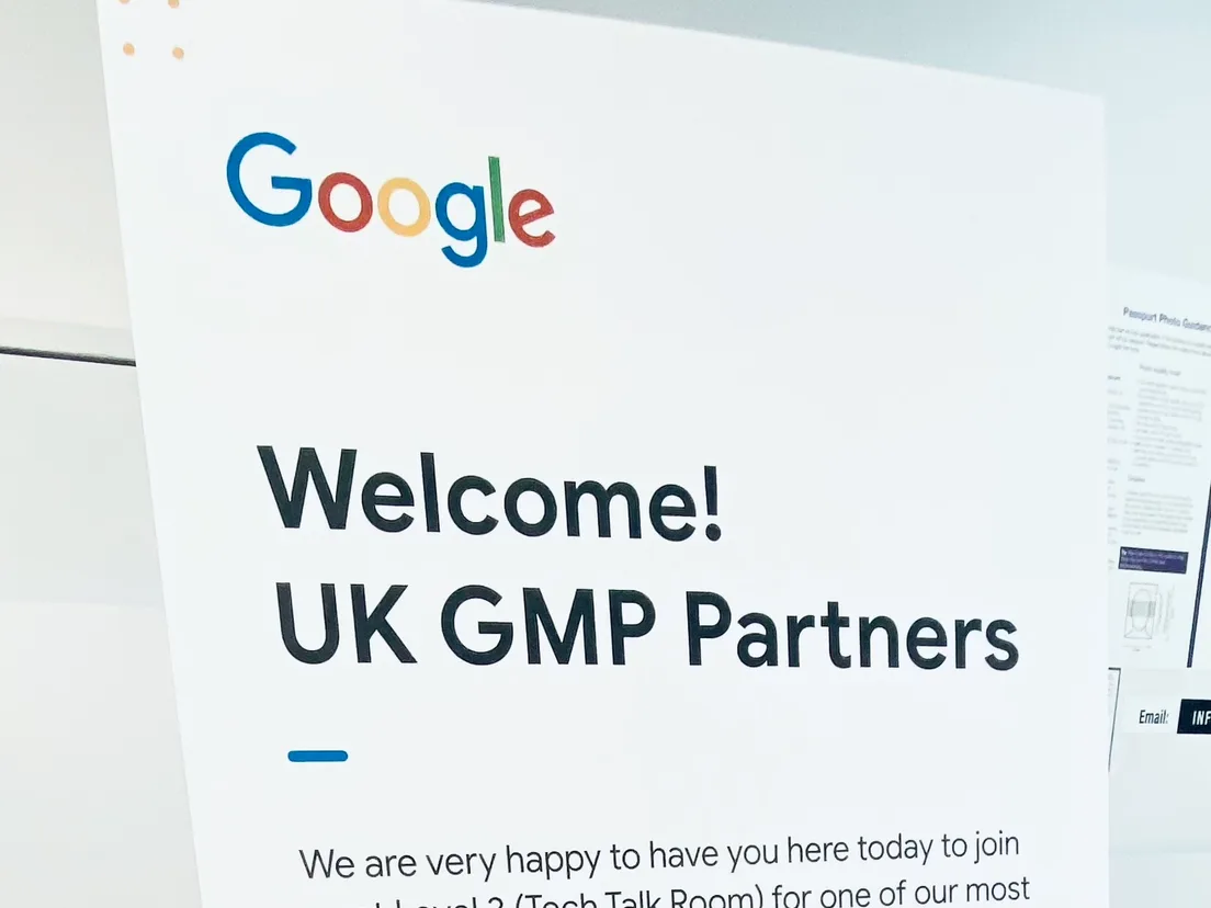 Google-branded welcome board reading Welcome UK GMP Partners on a metal easel stand