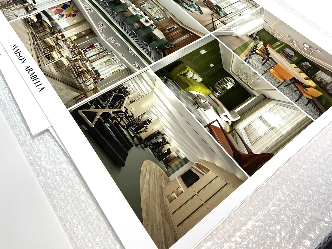 Close-up corner of a mounted board showing an architectural interior print and the white board edge beneath