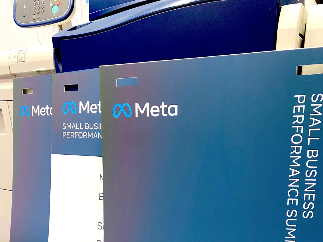 Tall blue Meta-branded exhibition boards reading Welcome London standing at a conference entrance