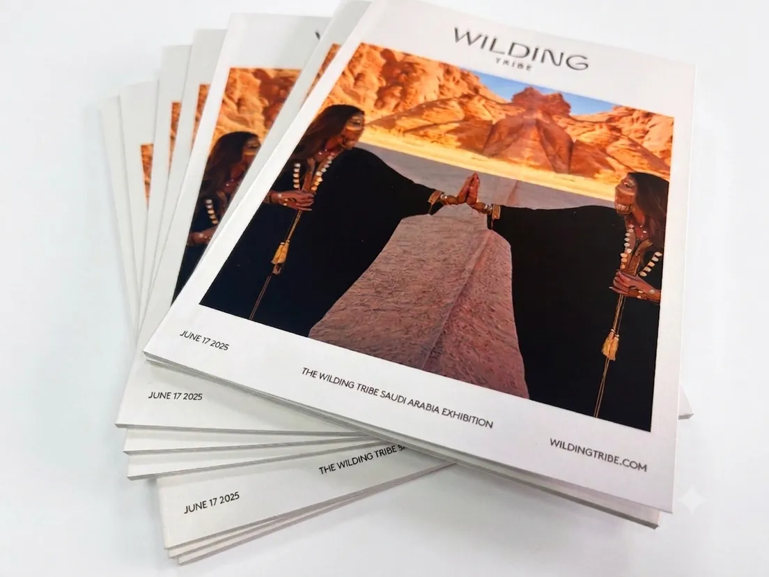 Stack of exhibition catalogues with a photographic cover, fanned to show clean white edges