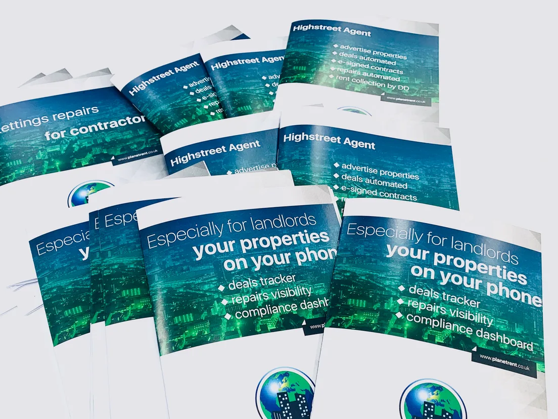 Spread of A5 property lettings brochures with green city-skyline covers laid out on a table