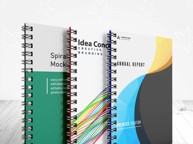 Several wire bound books fanned out with coloured covers and protruding tab dividers
