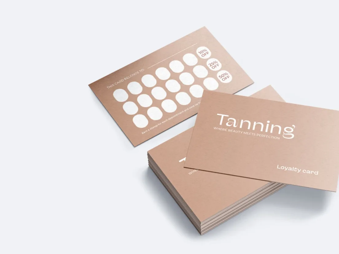 Neat stack of white minimal business cards on a pale grey surface