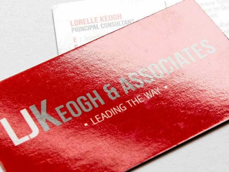 Business cards printed Morgan and Morgan resting in a wooden desk holder