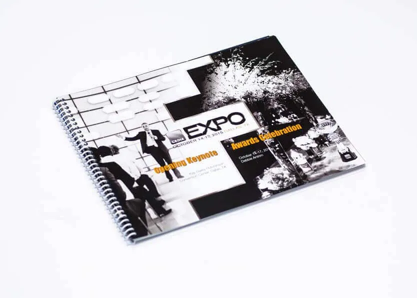 Wire bound A4 landscape conference brochure with a full-bleed photographic cover