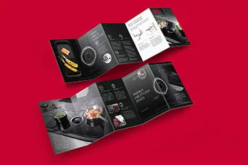 Dark tri-fold leaflet opened on a red background showing its three inside panels