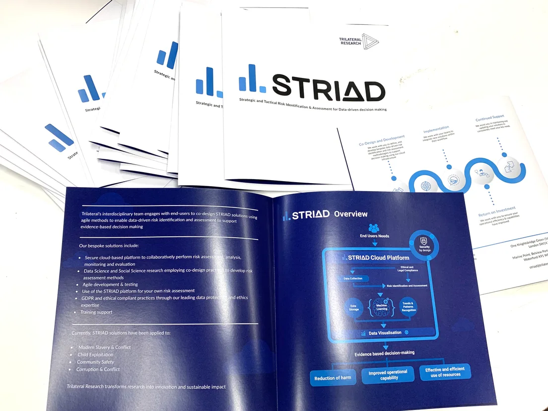 Stack of A4 corporate leaflets with one opened flat to show the inside spread and diagrams