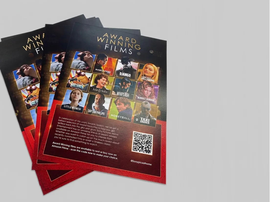 Stack of A5 film promotion flyers printed on gloss, with poster artwork and a QR code on the red panel