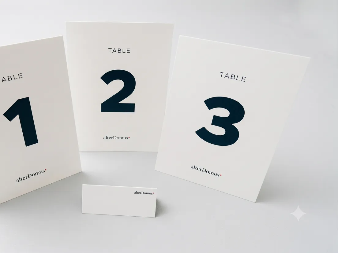 Alter Domus branded strut cards standing on a reception counter, printed for a corporate event